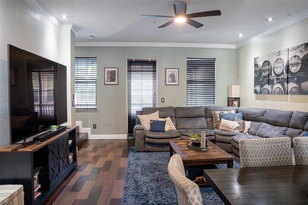 A living room features a grey sectional sofa, a television, and wood-look flooring — 2667 SW 118th Road, Miramar FL 33025, MIRAMAR, FL