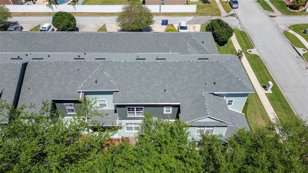 An aerial view shows the roof and exterior of a multi-unit residential building — 4510 CAPITAL BOULEVARD, ST CLOUD, FL
