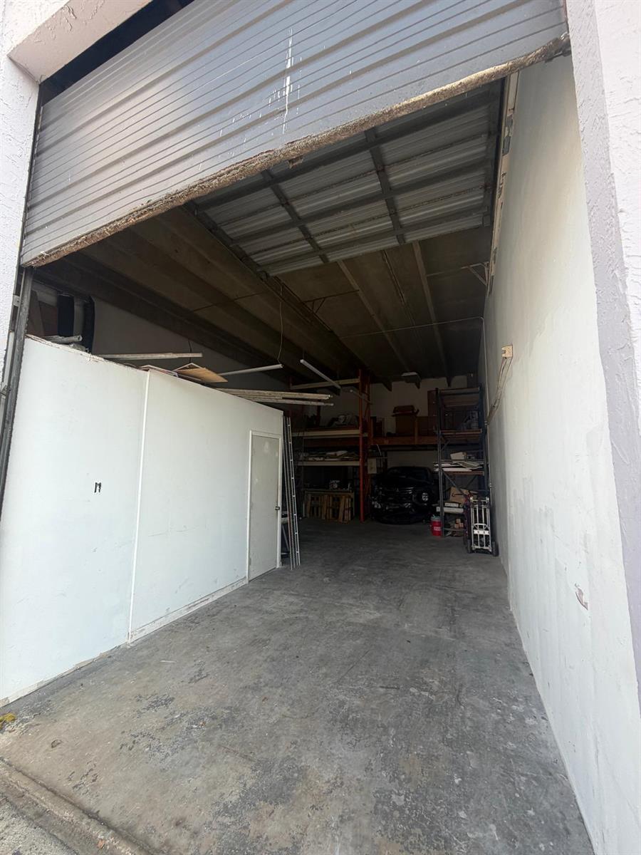 An open warehouse space features a concrete floor, high ceilings, and metal storage shelving — 1750 W 39th Place # 1005, Hialeah FL 33012, HIALEAH, FL
