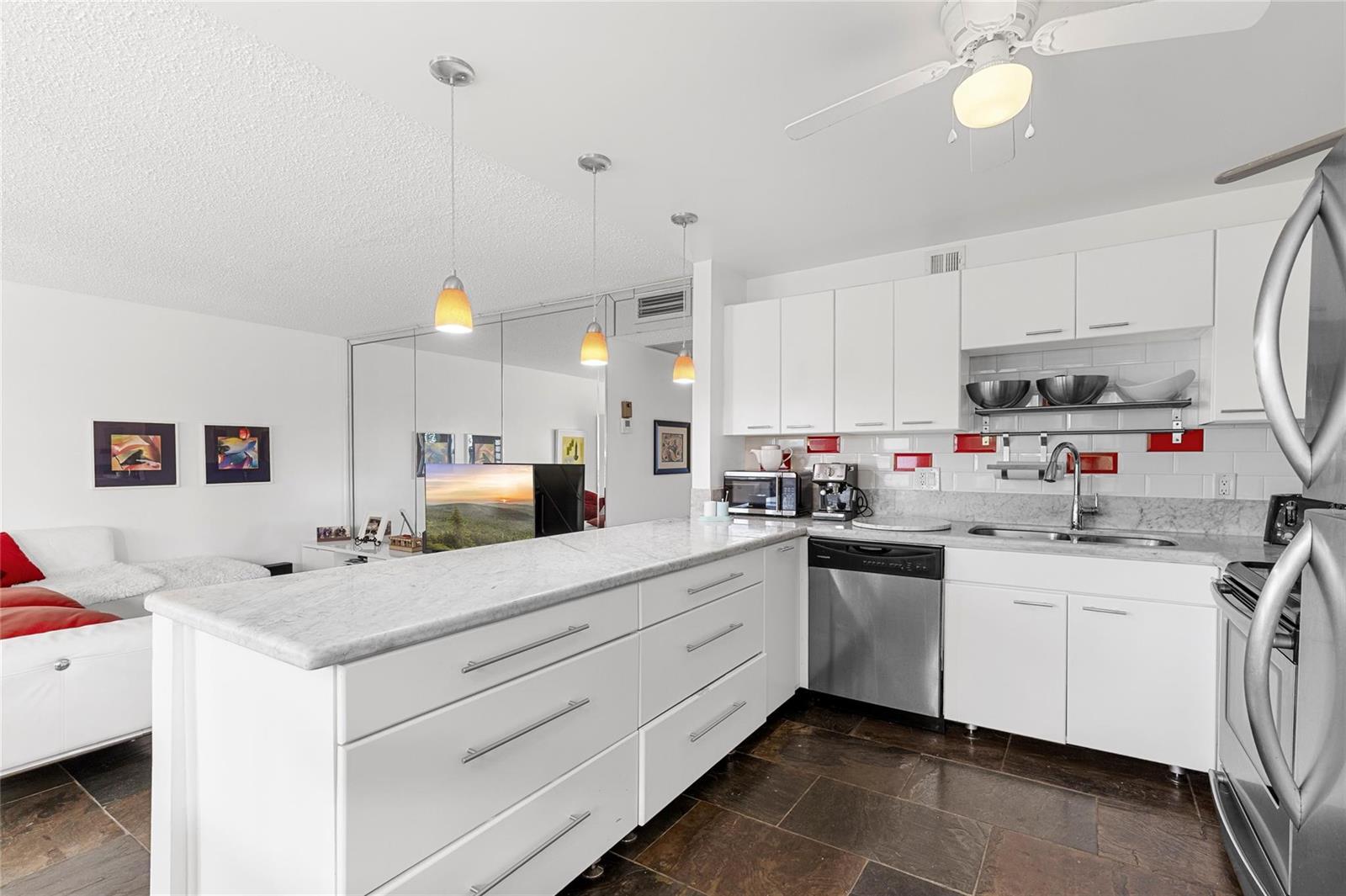 A kitchen with white cabinets, marble countertops, stainless steel appliances, and dark tile flooring — 4044 Ventnor O # 4044, Deerfield Beach FL 33442, DEERFIELD BEACH, FL
