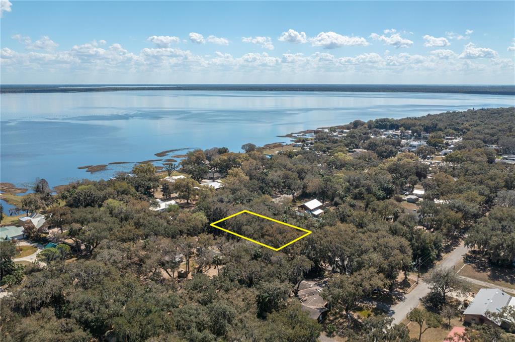 An aerial view shows a rectangular lot outlined in yellow amidst a wooded residential area — 0 W BEACH PARKWAY, LAKE WALES, FL