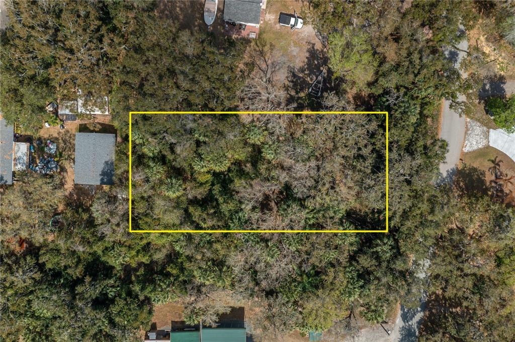 An aerial view shows a rectangular, tree-covered vacant lot outlined in yellow — 0 W BEACH PARKWAY, LAKE WALES, FL