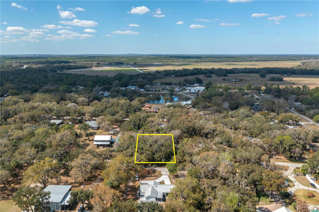 An aerial view shows a wooded, rectangular plot of land highlighted by a yellow border — 0 W BEACH PARKWAY, LAKE WALES, FL