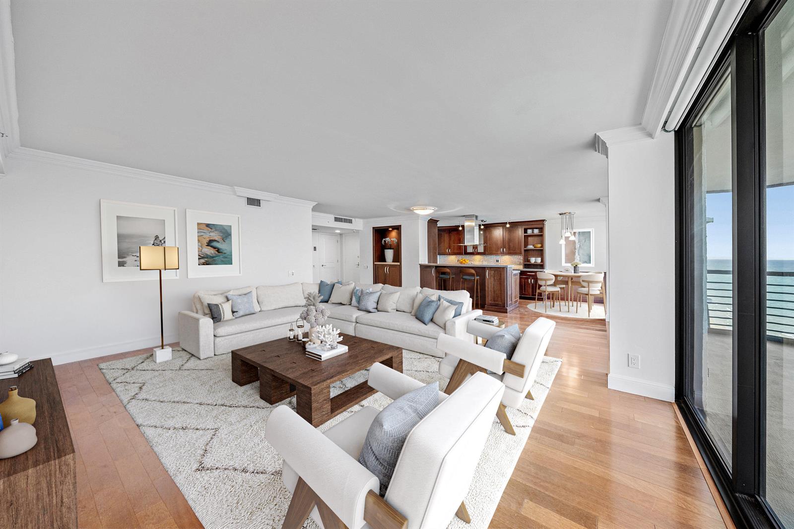 An open-concept living room and kitchen with hardwood floors, a large sectional, and ocean views — 250 S Ocean Boulevard # 11c, Boca Raton FL 33432, BOCA RATON, FL