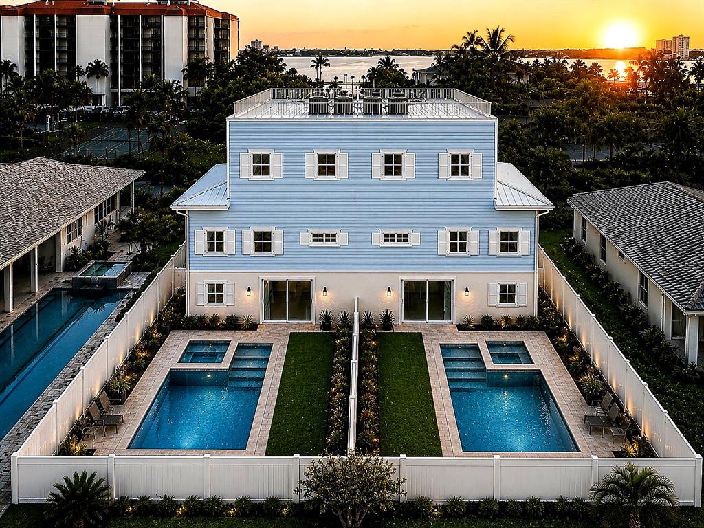 An aerial view of a light blue duplex with two private pools and fenced yards — 7045 HIBISCUS, SOUTH PASADENA, FL