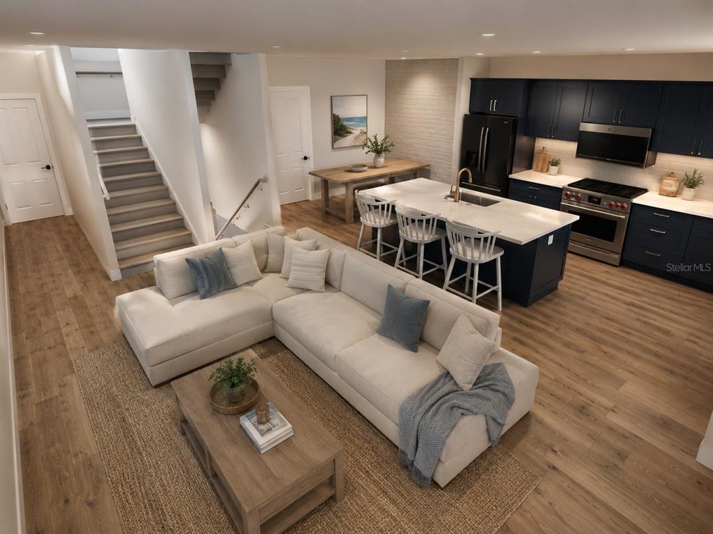This is a rendering of an open-concept living room and kitchen with dark blue cabinetry — 7045 HIBISCUS, SOUTH PASADENA, FL