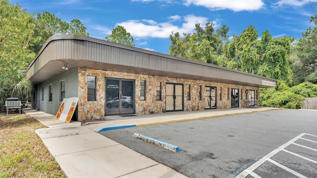 A single-story commercial building with a stone facade, flat roof, and an adjacent parking lot — 4314 N SUNCOAST BOULEVARD, CRYSTAL RIVER, FL