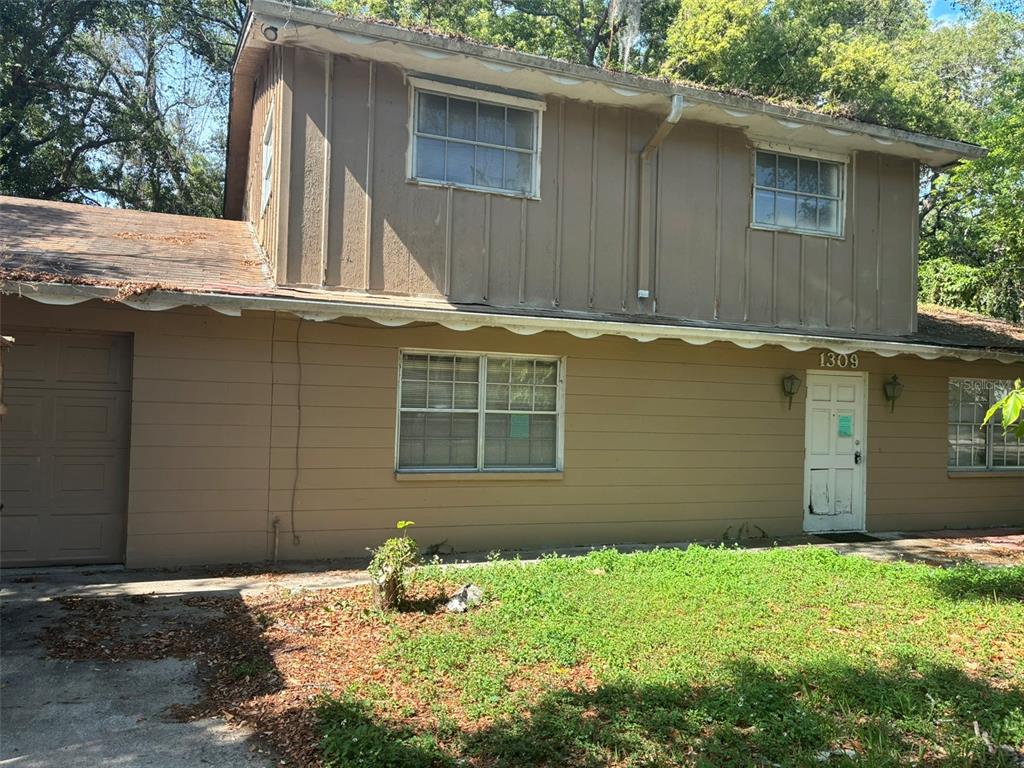 A two-story house with brown vertical and horizontal siding and a front-facing garage — 1309 W RAMBLA STREET, TAMPA, FL