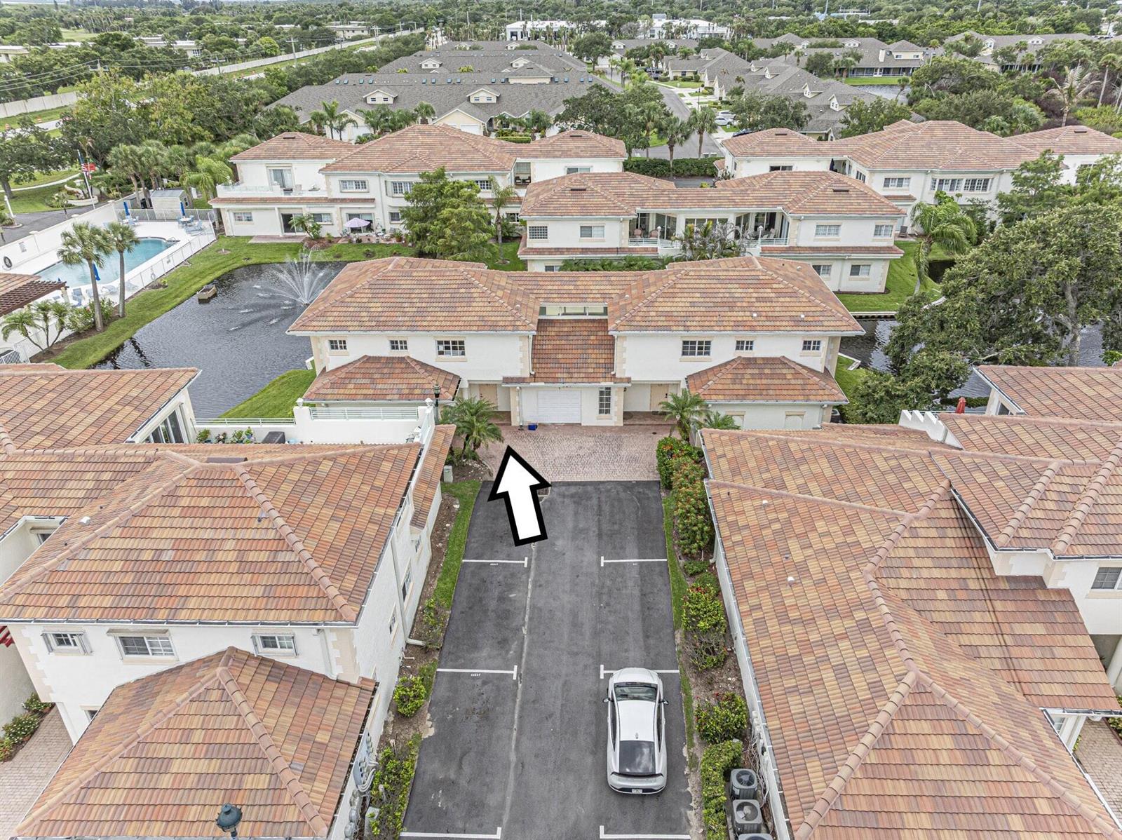 An aerial view shows a two-story residential building with a tiled roof and parking area — 524 7th Square # 101, Vero Beach FL 32962, VERO BEACH, FL