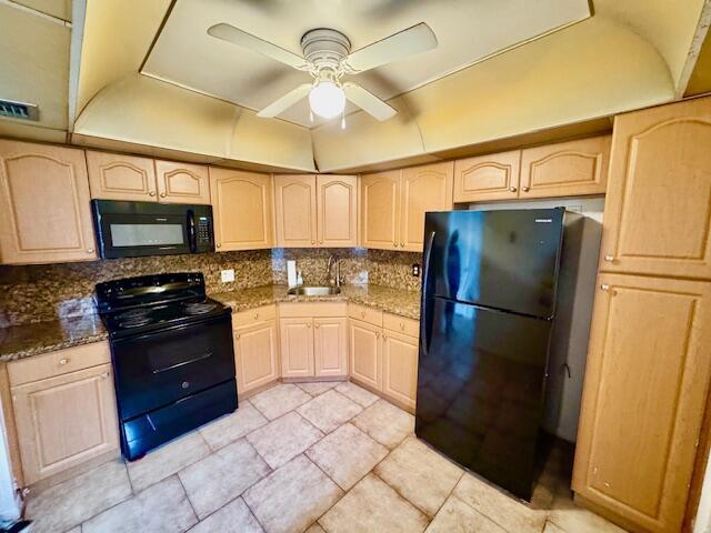 A kitchen features light wood cabinets, black appliances, granite countertops, and a ceiling fan — 3300 Spanish Moss Terrace # 302, Lauderhill FL 33319, LAUDERHILL, FL