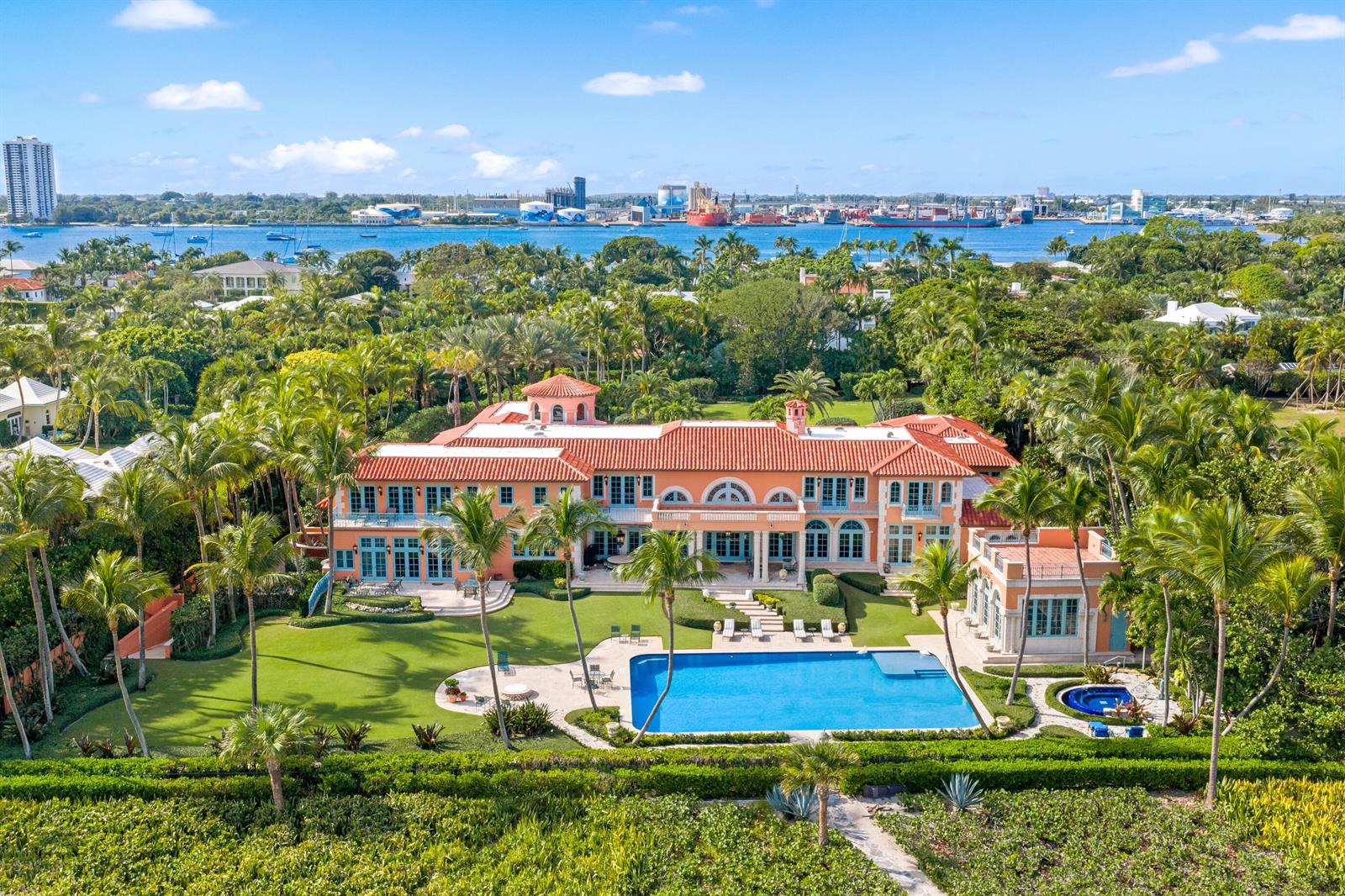 An aerial view of a large peach-colored mansion with a pool and lush landscaping — 1491 N Ocean Boulevard, Palm Beach FL 33480, PALM BEACH, FL