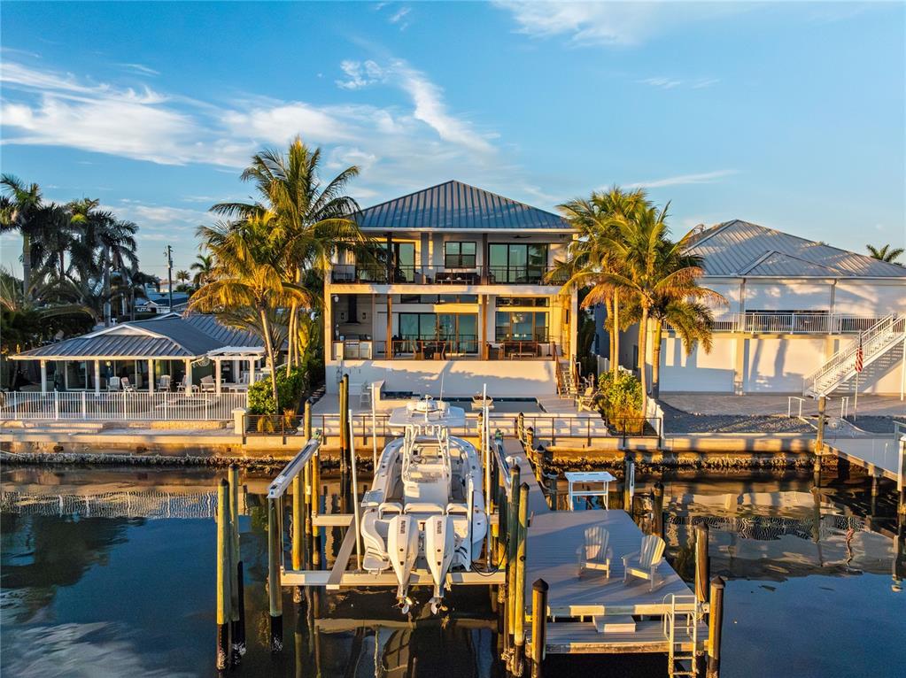 An aerial view of a waterfront house with a boat lift and private dock — 459 20TH AVENUE, INDIAN ROCKS BEACH, FL