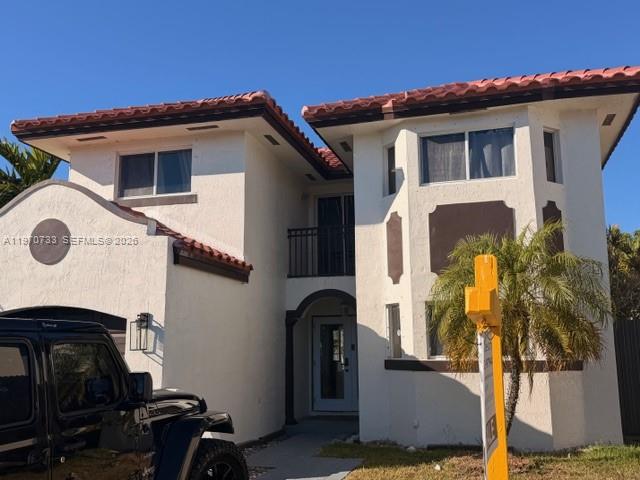 A two-story white stucco house with a red tile roof and a black Jeep parked outside — 14127 SW 166th St, Miami FL 33177, MIAMI, FL