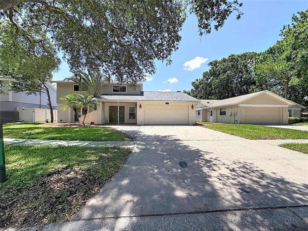 A two-story house with a two-car garage and a separate adjacent garage structure — 15708 WOODCOCK PLACE, TAMPA, FL