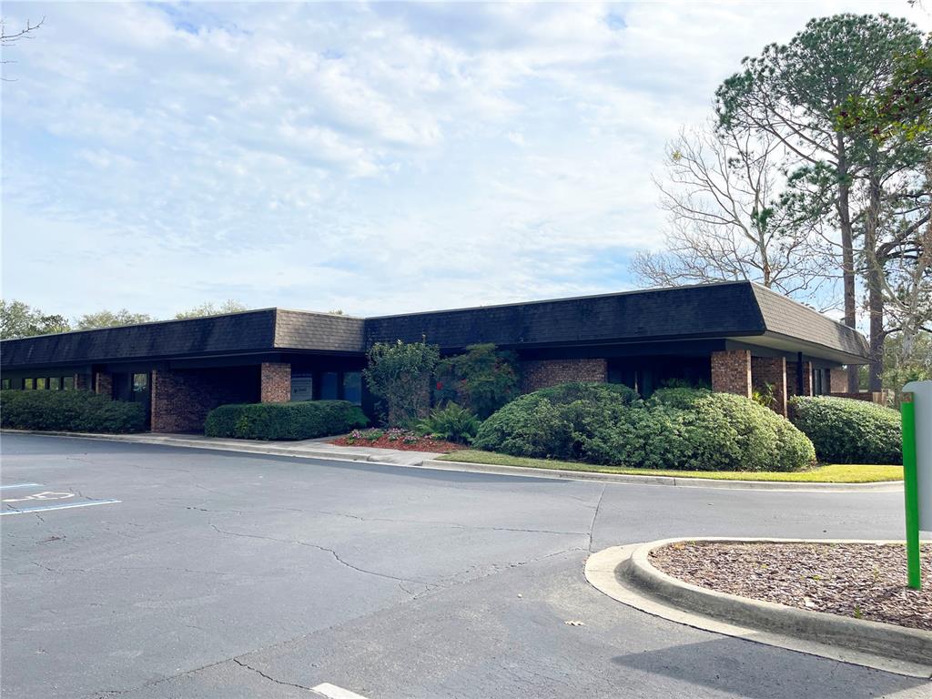 A single-story commercial building with a dark mansard roof and brick facade — 6628 NW 9TH BOULEVARD NW UNIT 4, GAINESVILLE, FL
