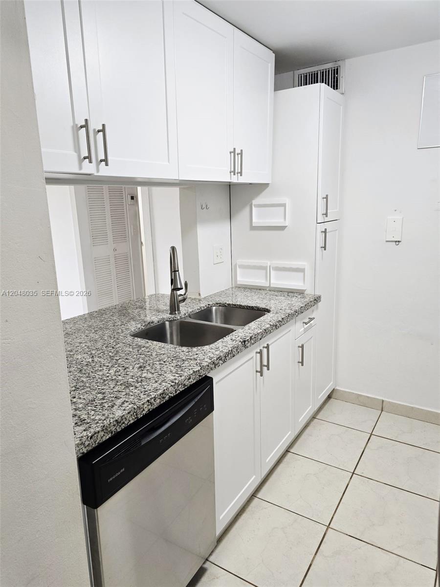 A kitchen features white cabinets, granite countertops, a stainless steel sink, and a dishwasher — 8877 Fontainebleau Blvd # 202, Miami FL 33172, MIAMI, FL