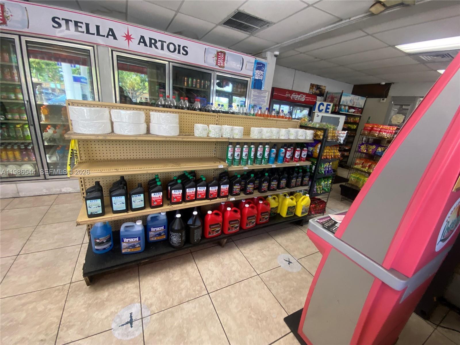 A convenience store interior features shelves stocked with automotive fluids and various retail items — 5390 NE 2nd Ave, Miami FL 33137, MIAMI, FL