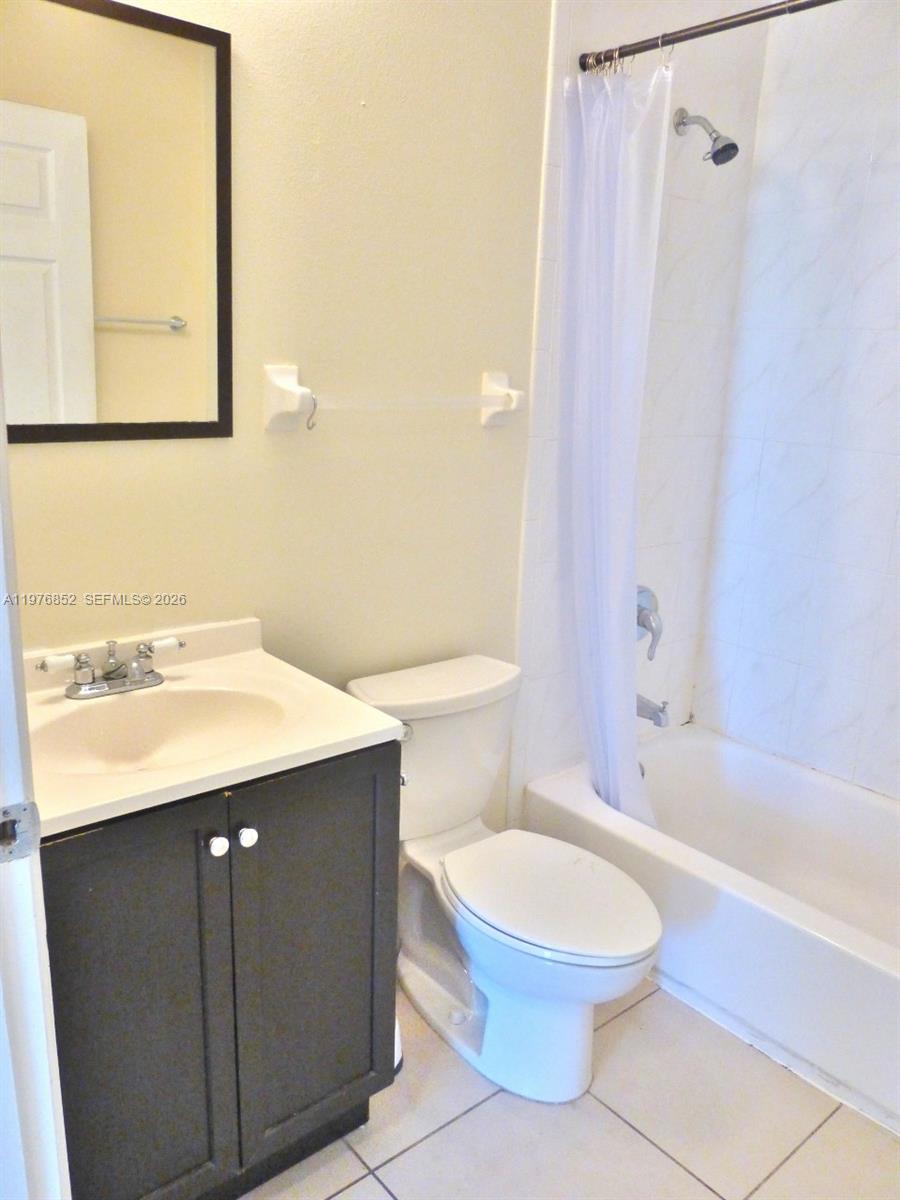 A bathroom features a dark vanity, a white toilet, and a shower-tub combination — 843 SW 13th AV # 201, Miami FL 33135, MIAMI, FL