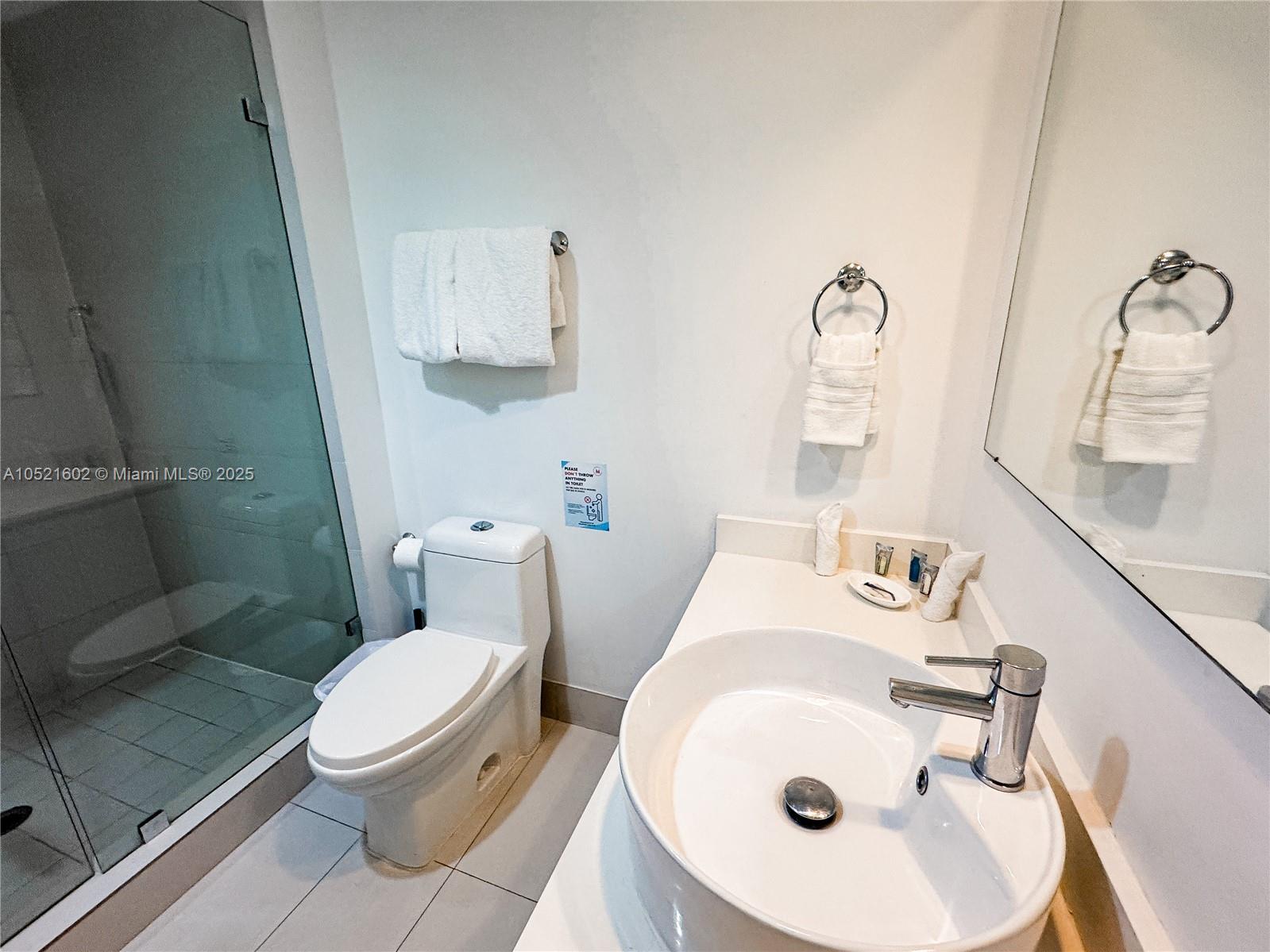 A modern bathroom features a white vessel sink, a toilet, and a glass-enclosed shower — 2600 E Hallandale Beach # 3104, Hallandale Beach FL 33009, HALLANDALE BEACH, FL