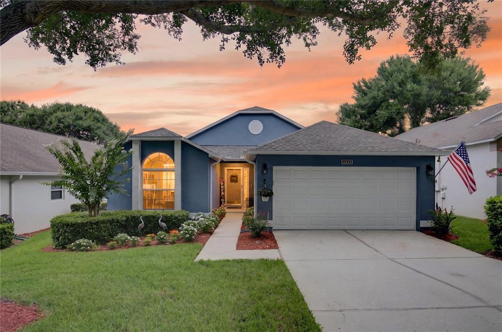 An entryway features a white console table, a mirror, and an open door to outside — 4059 CAPLAND AVENUE, CLERMONT, FL