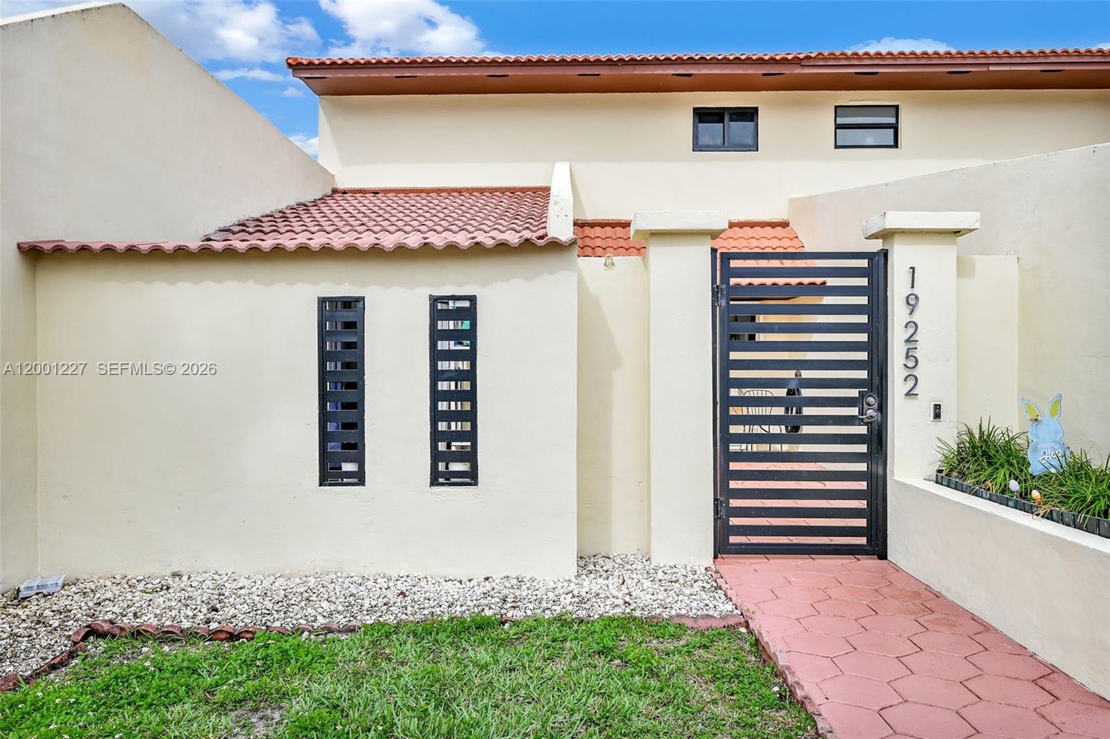 An aerial view shows a row of townhouses with a highlighted unit featuring a backyard — 19252 NW 65th Ct, Hialeah FL 33015, HIALEAH, FL