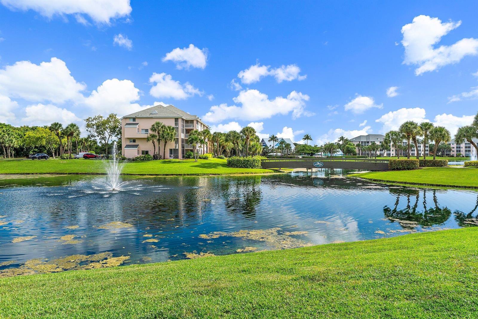 A fountain sprays water in a pond in front of a multi-story apartment building — 353 S Us Hwy 1 # B8, Jupiter FL 33477, JUPITER, FL