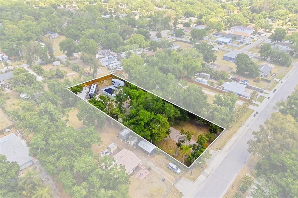 An aerial view shows a rectangular lot with trees, a small structure, and two trailers — 2549 19TH STREET, SARASOTA, FL