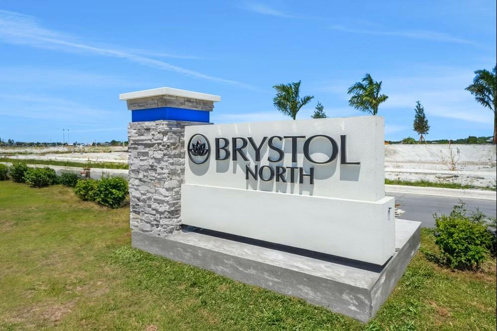 A stone and concrete monument sign for Brystol North stands in a grassy field — 5428 NW CAMBERLY COURT, PORT ST LUCIE, FL
