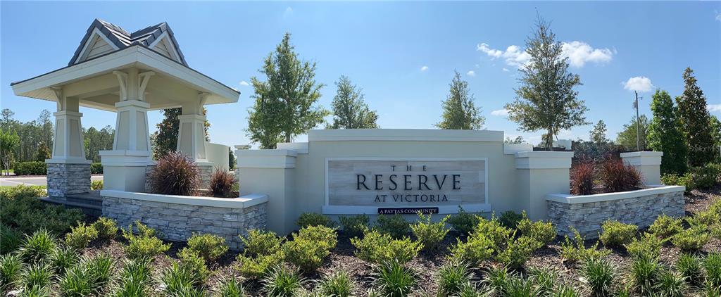 A stone and stucco monument sign marks the entrance to The Reserve at Victoria community — 986 MEGANO BOULEVARD, DELAND, FL