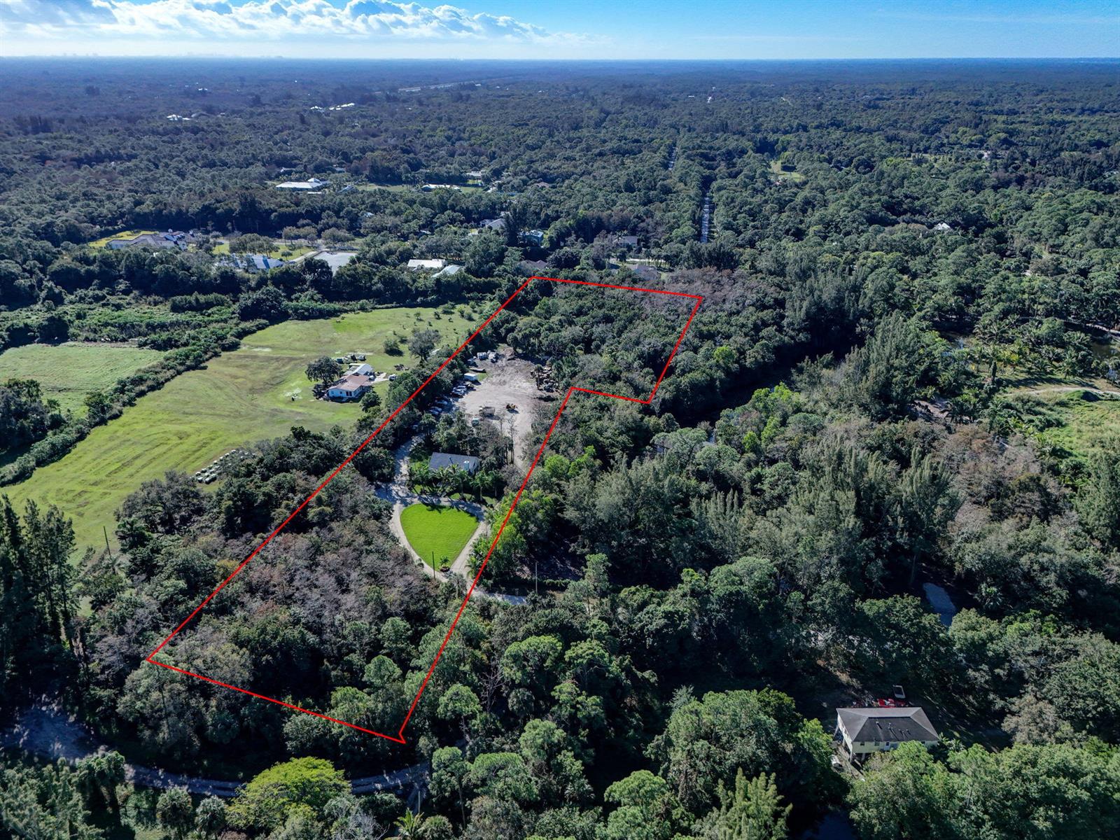 An aerial view shows a large, wooded property outlined in red with a central clearing — 9576 171st Street N, Jupiter FL 33478, JUPITER, FL