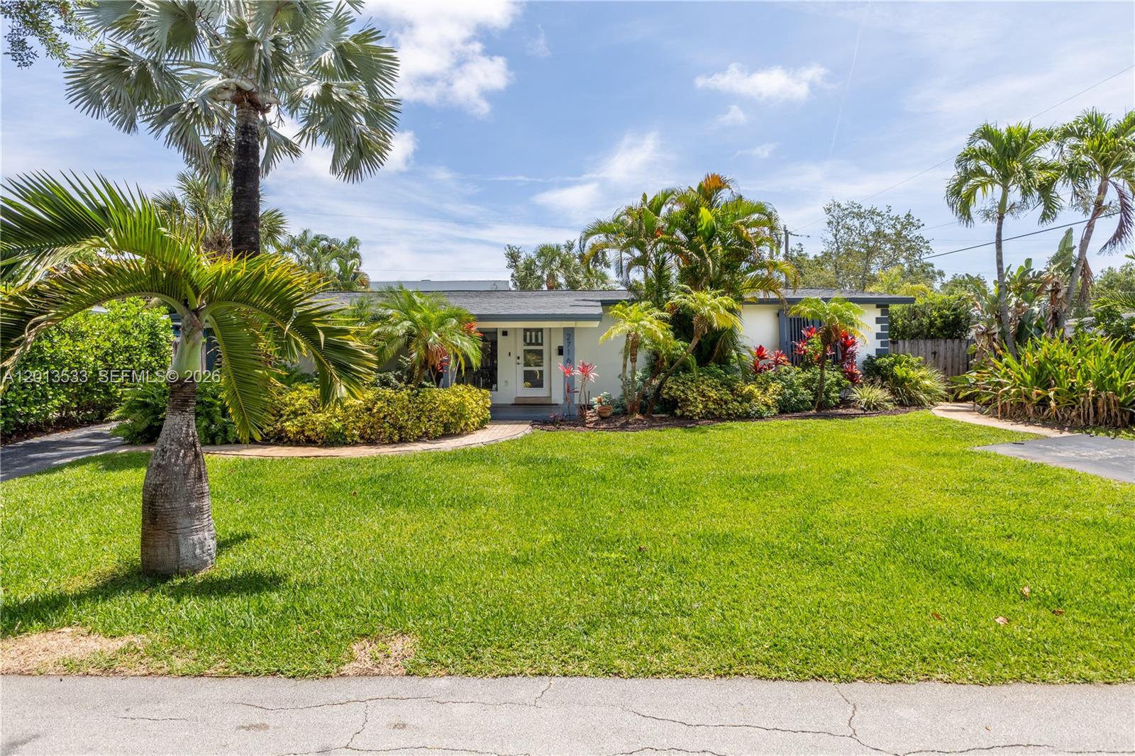 A single-story house with a white exterior, palm trees, and a green lawn — 2716 NW 3rd Ave, Wilton Manors FL 33311, WILTON MANORS, FL