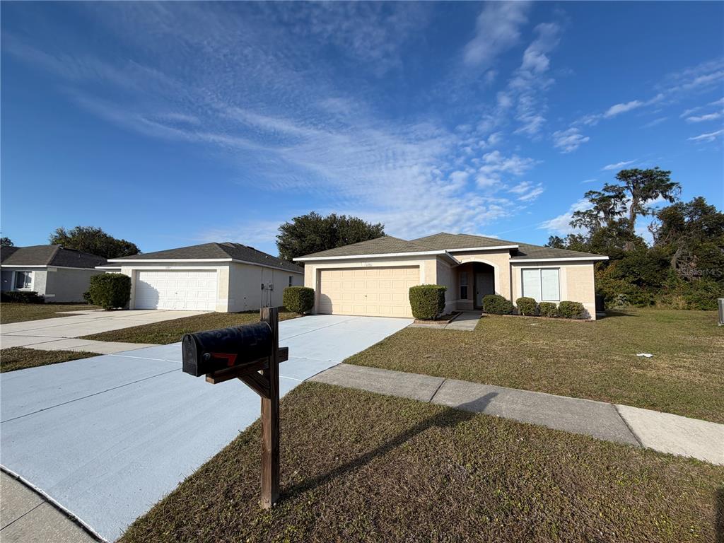 A single-story suburban house with a two-car garage, a driveway, and a front lawn — 11701 BRENFORD CREST DRIVE, RIVERVIEW, FL