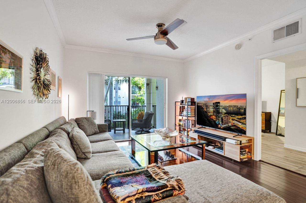 A living room features a grey sectional sofa, a glass coffee table, and a television — 2220 Tuscany Way # 2220, Boynton Beach FL 33435, BOYNTON BEACH, FL