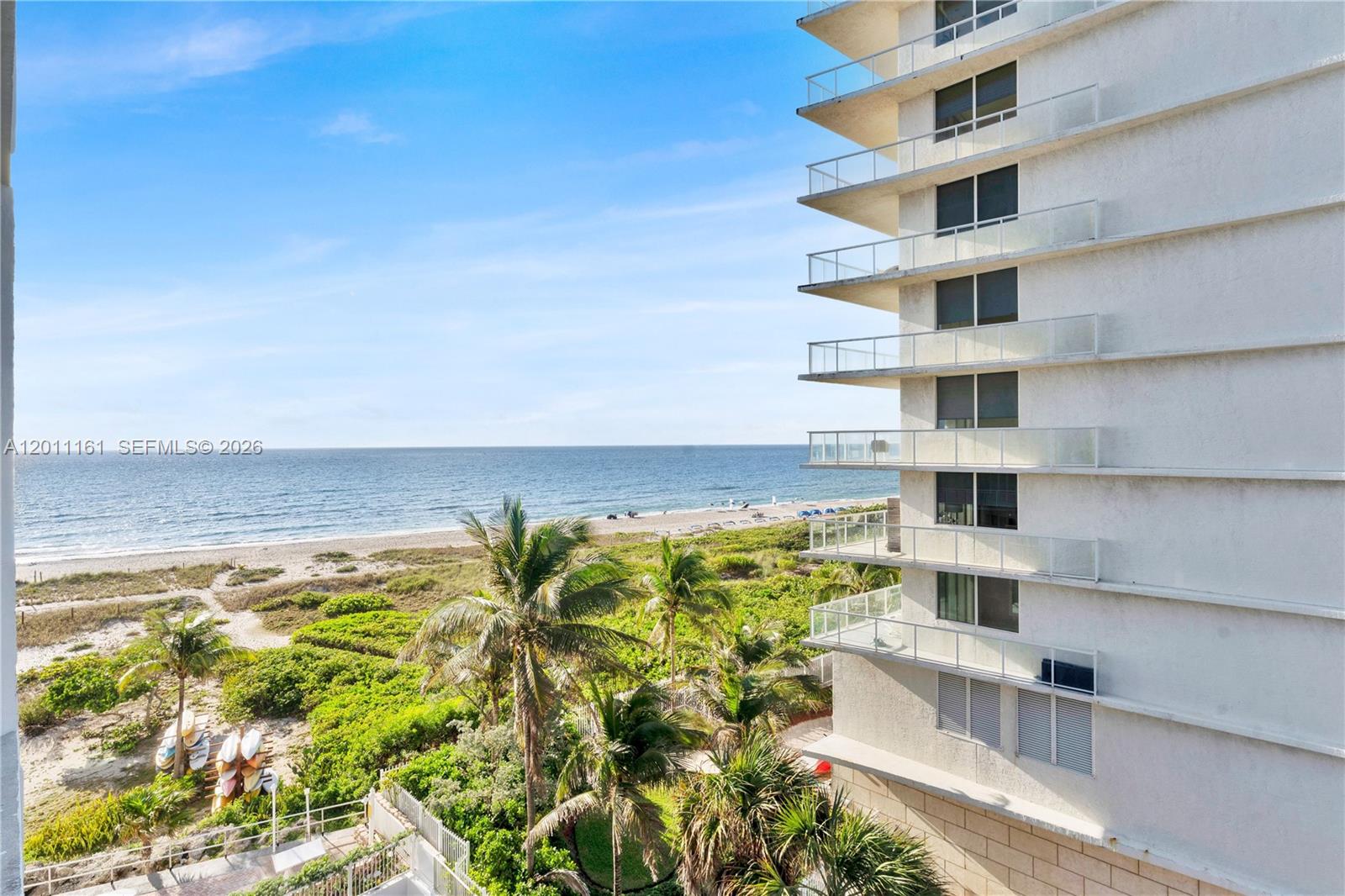 An exterior view shows a multi-story building balcony overlooking a beach and the ocean — 710 N Ocean Blvd # 511, Pompano Beach FL 33062, POMPANO BEACH, FL