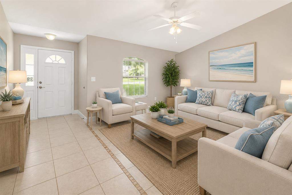 A living room features light tile floors, a beige sofa, an armchair, and a coffee table — 39 PINWHEEL LANE, PALM COAST, FL