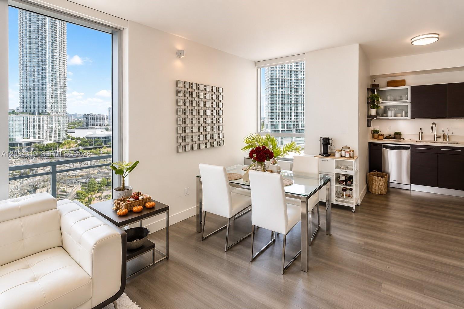 A modern dining area with a glass table, white chairs, and a city view — 90 SW 3rd St # 1413, Miami FL 33130, MIAMI, FL