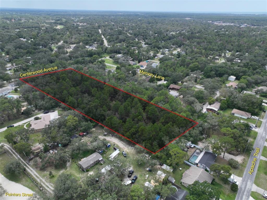 An aerial view shows a rectangular, wooded vacant lot outlined in red near residential streets — 0 CENTERWOOD AVENUE, SPRING HILL, FL