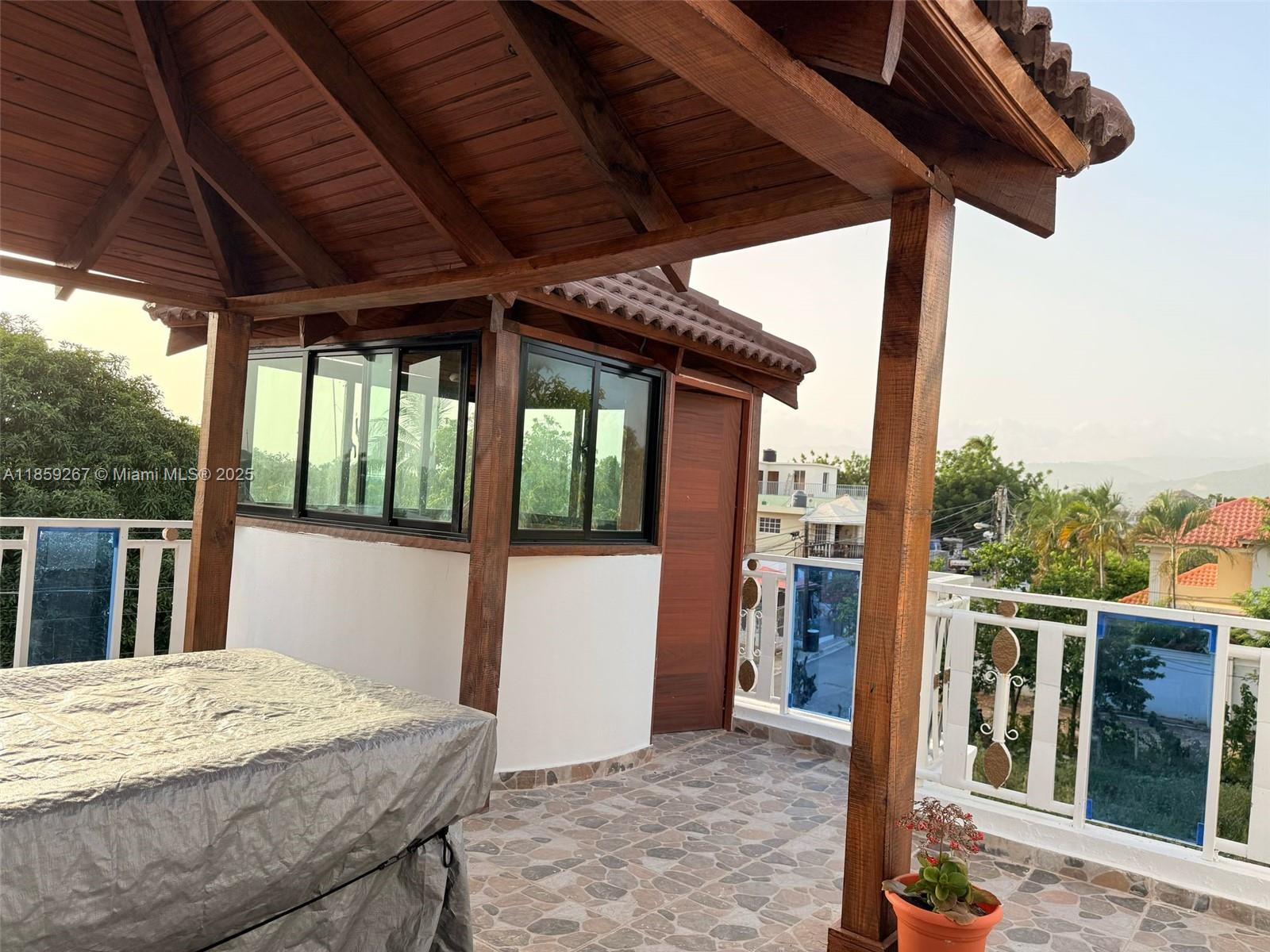 A rooftop terrace features a covered wooden structure, a small enclosed room, and tiled flooring — San Jose # 24 San Jose #24, DR, DR