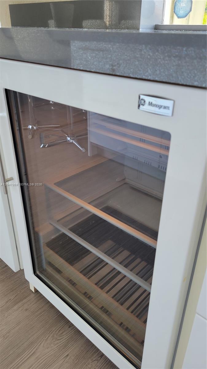 A white Monogram glass-front refrigerator is installed under a gray countertop in a kitchen — 8780 SW 223rd Ter # 8780, Cutler Bay FL 33190, CUTLER BAY, FL