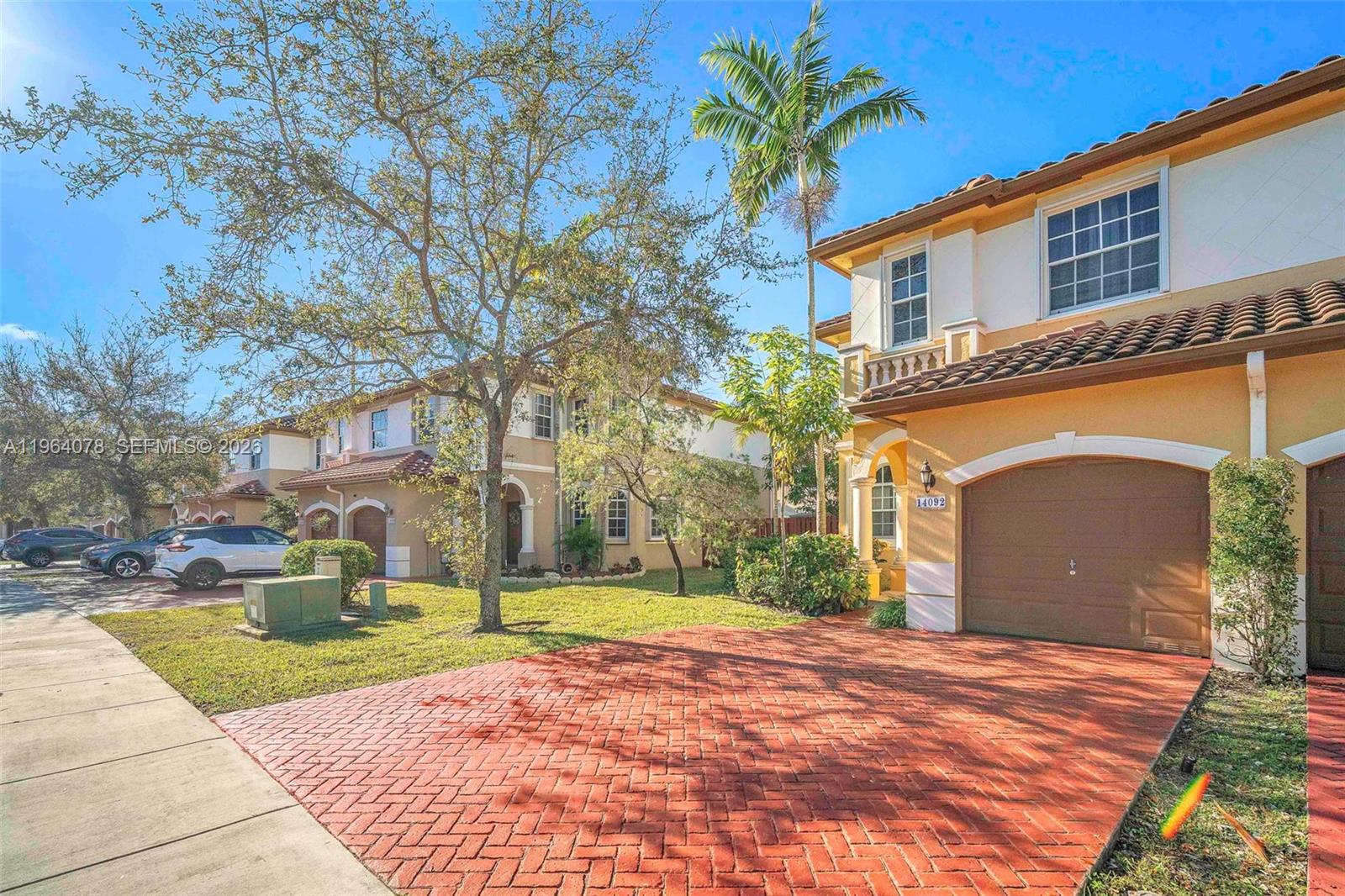 A two-story house with a brick driveway, a garage, and a palm tree in front — 14092 SW 51st Ct, Miramar FL 33027, MIRAMAR, FL