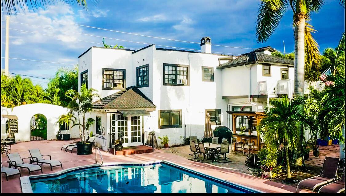 A white two-story house with a swimming pool and patio area in the backyard — 701 W Ocean Avenue, Boynton Beach FL 33426, BOYNTON BEACH, FL