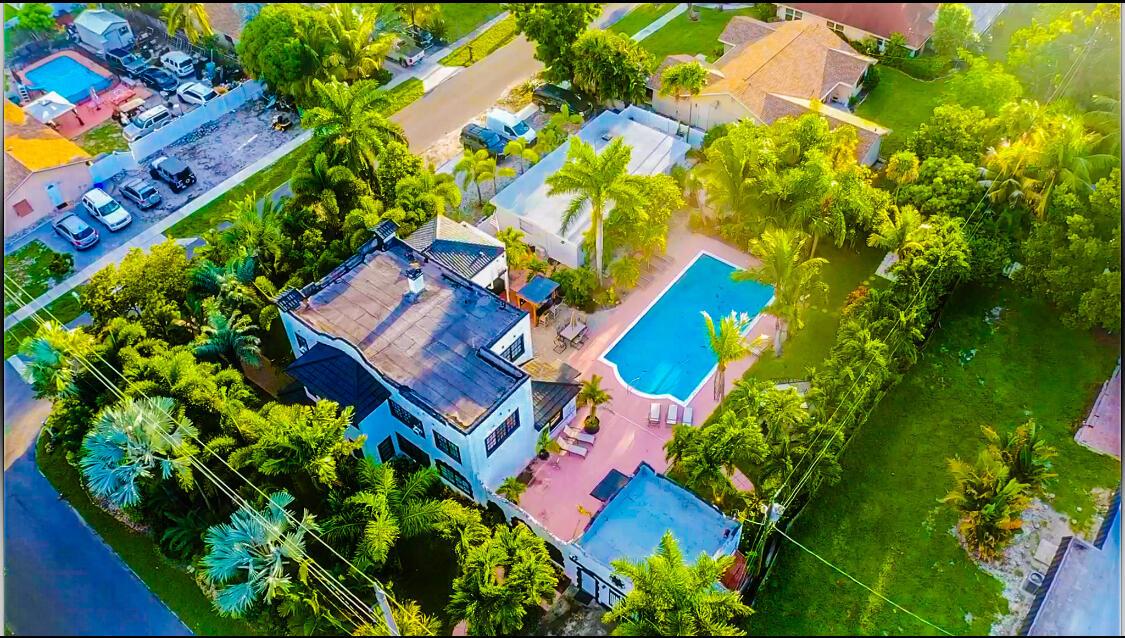 An aerial view shows a house with a flat roof, a swimming pool, and lush landscaping — 701 W Ocean Avenue, Boynton Beach FL 33426, BOYNTON BEACH, FL