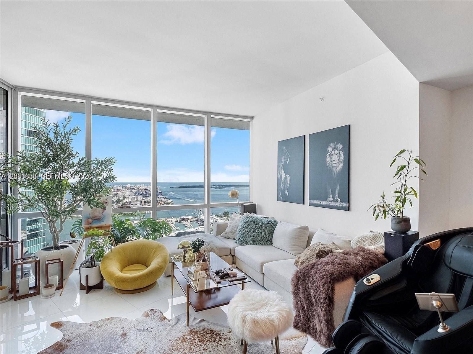 A living room features a white sectional sofa, a yellow chair, and floor-to-ceiling windows — 851 NE 1st Ave # 4109, Miami FL 33132, MIAMI, FL