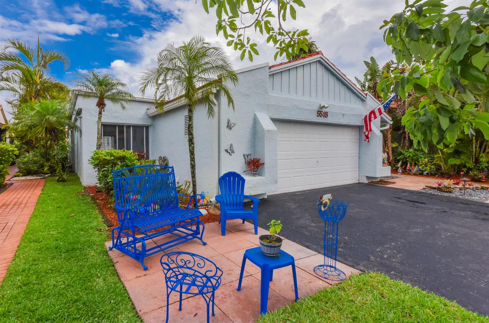A light blue house with a garage, a front patio, and several bright blue chairs — 5518 Ainsley Court, Boynton Beach FL 33437, BOYNTON BEACH, FL