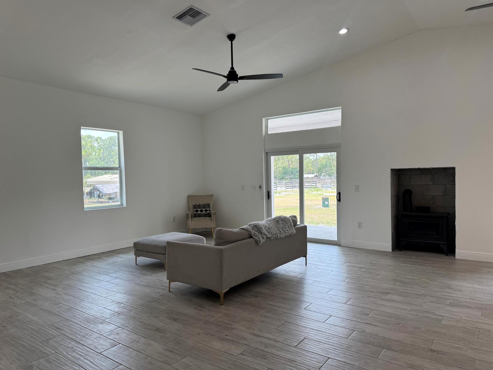 A white, single-story house with a covered porch sits on a grassy lawn — 12851 NE 26th Avenue, Okeechobee FL 34972, OKEECHOBEE, FL