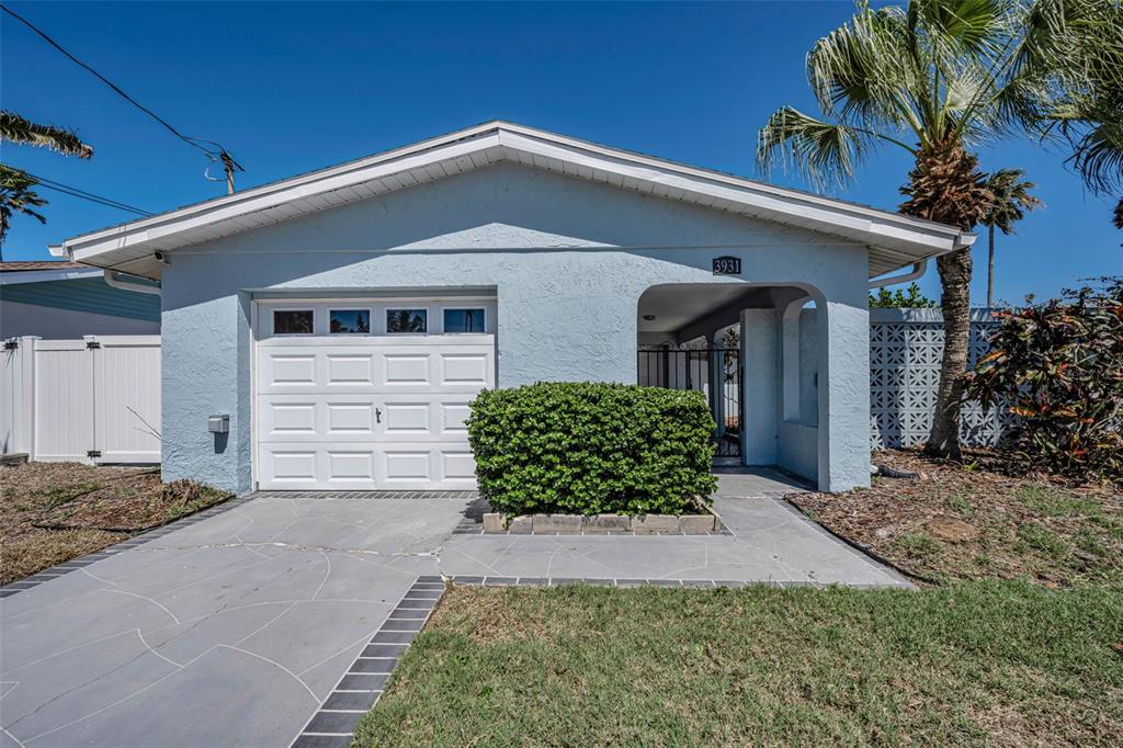 A light blue house features a single-car garage, a front porch, and a paved driveway — 3931 HEADSAIL DRIVE, NEW PORT RICHEY, FL