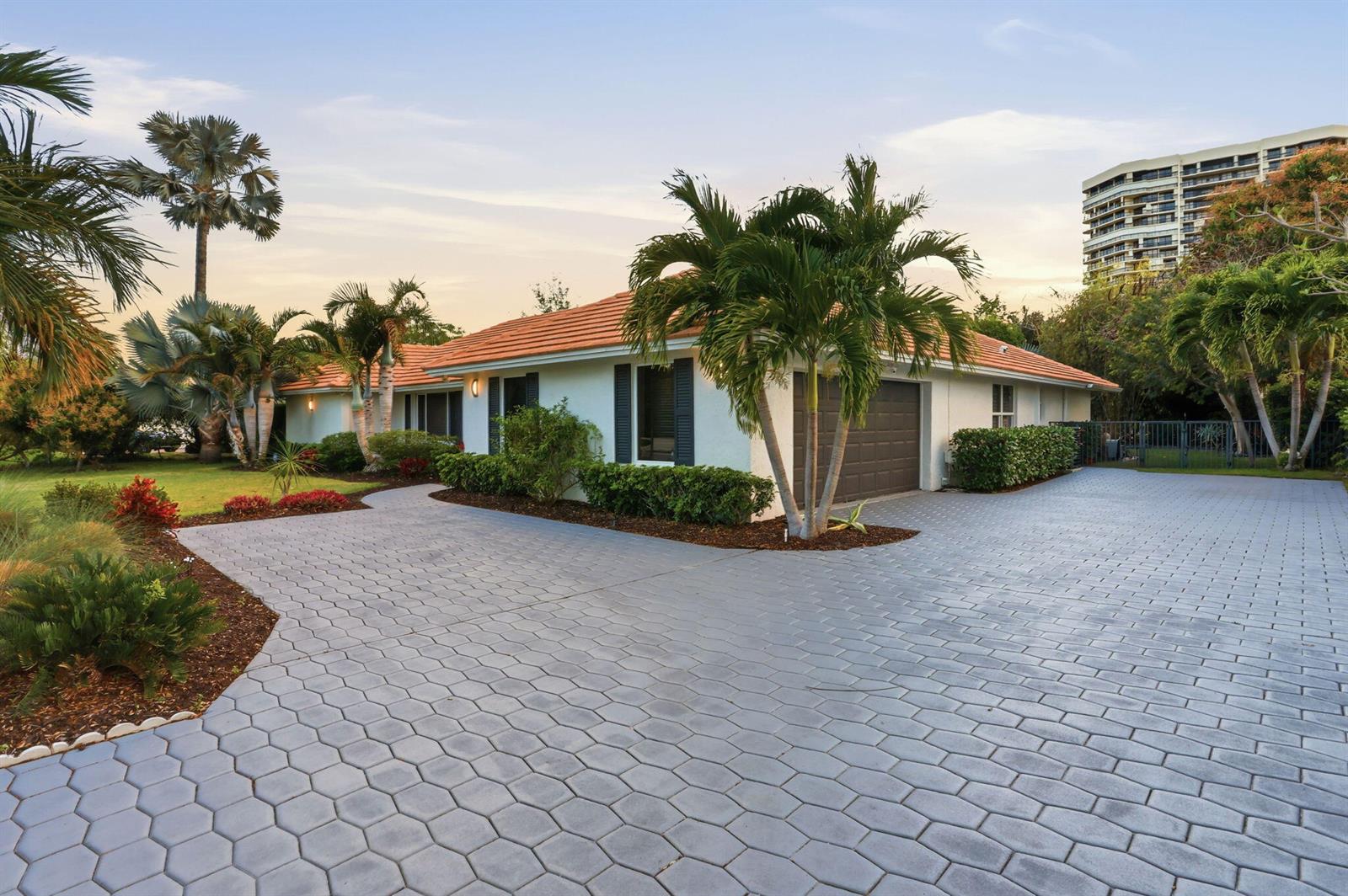 A single-story house with a tiled roof, a paved driveway, and palm trees in the yard — 2001 Embassy Drive, West Palm Beach FL 33401, WEST PALM BEACH, FL