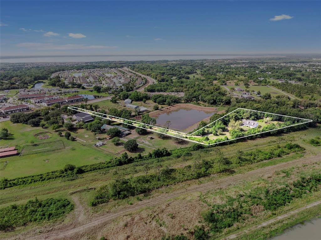 An aerial view shows a house and pond within a white-outlined property boundary — 4385 BOGGY CREEK ROAD, KISSIMMEE, FL