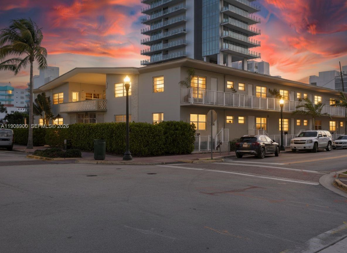 A two-story apartment building with a balcony and a tall high-rise tower behind it — 101 Collins Ave # 2, Miami Beach FL 33139, MIAMI BEACH, FL