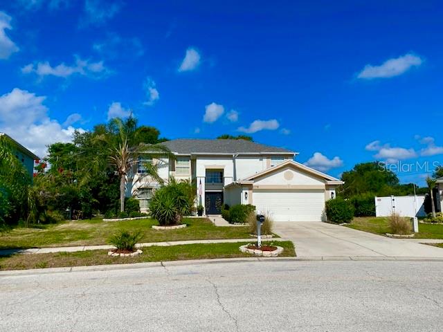 A two-story house with a white exterior, a two-car garage, and a palm tree — 11718 STONEWOOD GATE DRIVE, RIVERVIEW, FL